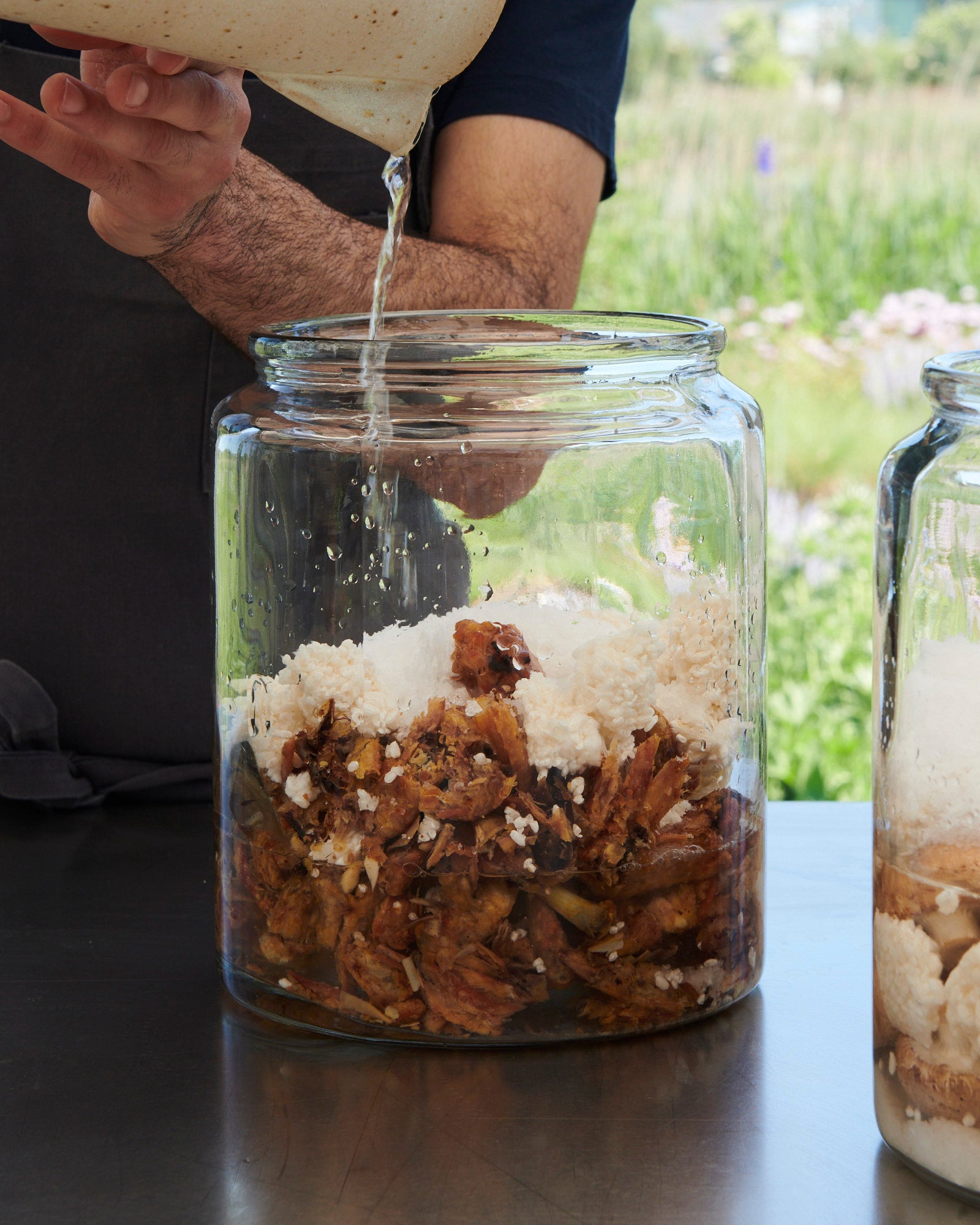 Noma's head of the fermentation lab straining garum